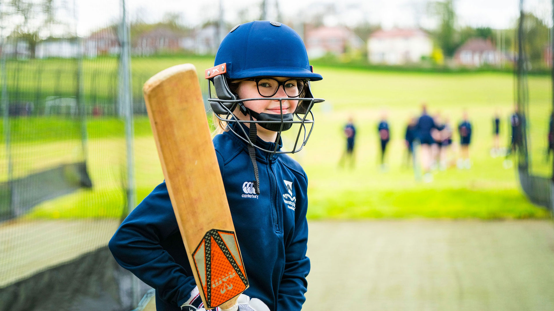 Student at Oswestry School playing cricket in the sports facilities.